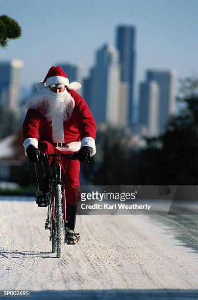 santa claus bike riding - claus lange stock pictures, royalty-free photos & images