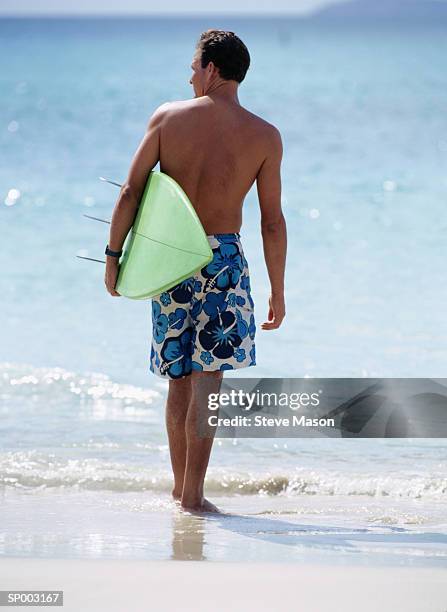 surfer with surfboard - lesser antilles foto e immagini stock