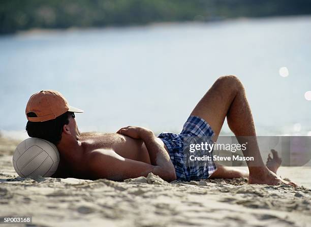 resting on the volleyball - man sleeping with cap stock pictures, royalty-free photos & images