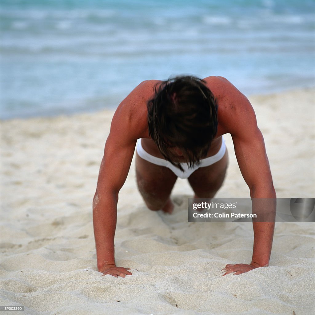 Man Doing Pushups on the Beach