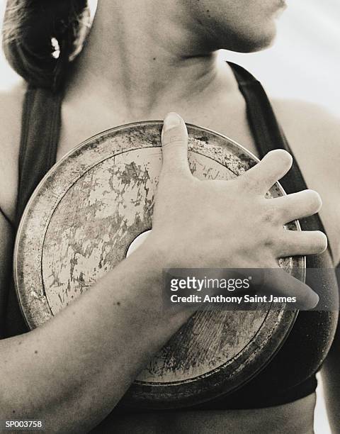 woman holding discus - women's field event foto e immagini stock