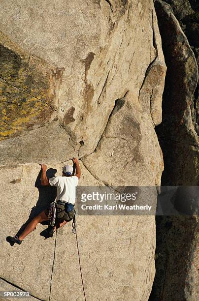 rock climbing on cliff - soloing stock pictures, royalty-free photos & images