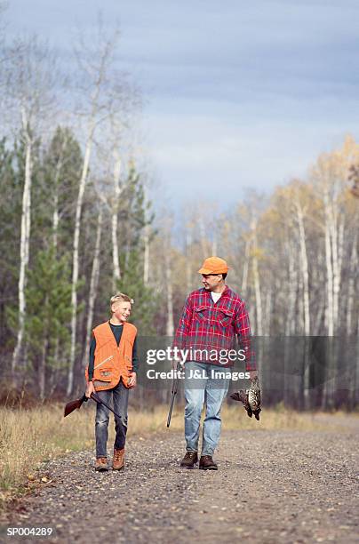 father and son on hunt - animal sport stock pictures, royalty-free photos & images