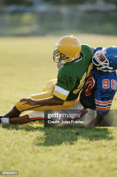 tackle - american football uniform stock pictures, royalty-free photos & images