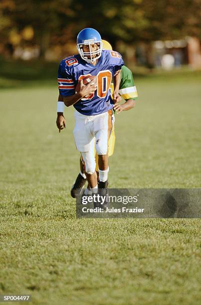 running for a touchdown - american football uniform stock pictures, royalty-free photos & images