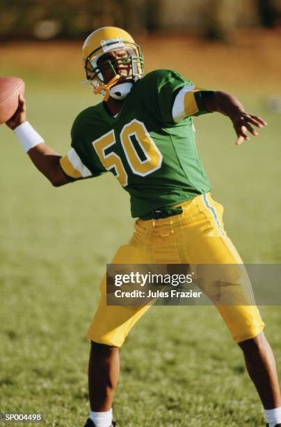 throwing a football - american football uniform stock pictures, royalty-free photos & images