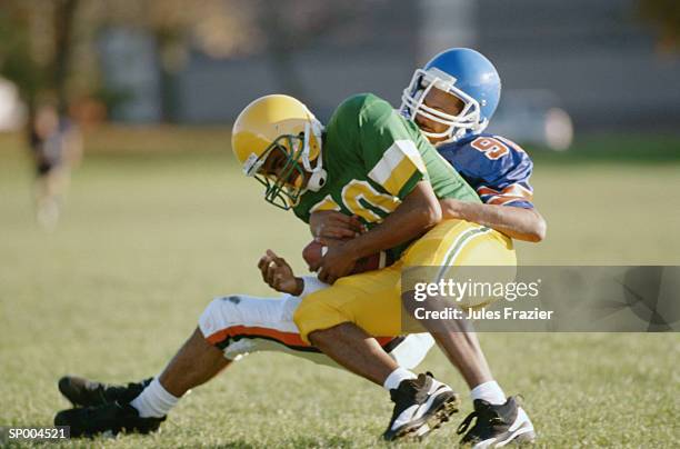 tackle - american football uniform stock pictures, royalty-free photos & images
