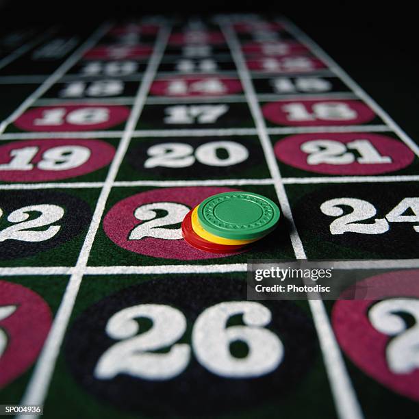 gambling chips on a roulette table - gambling table stock pictures, royalty-free photos & images