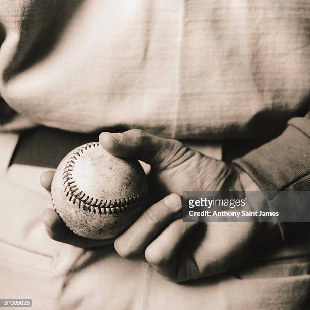 baseball player holding ball, rear view, close-up (toned b&w) - the uk gala premiere of w e after party stockfoto's en -beelden