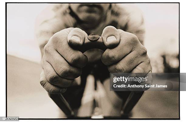 cyclist's hands gripping handlebar - saint anthony stock pictures, royalty-free photos & images