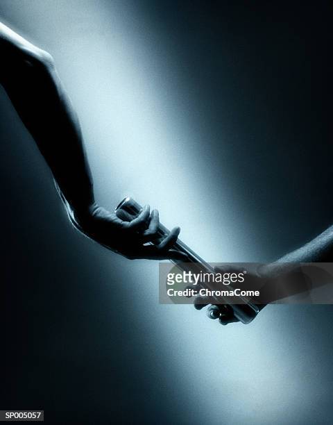 baton hand off - sports competition format stock pictures, royalty-free photos & images