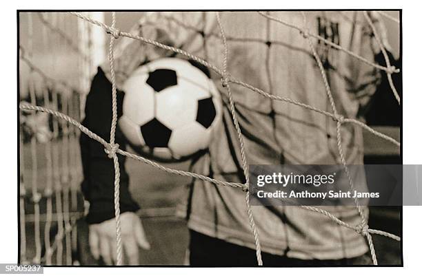 goalie with ball through net - saint anthony stock pictures, royalty-free photos & images