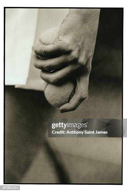 close-up of hand with tennis ball - saint anthony stock pictures, royalty-free photos & images