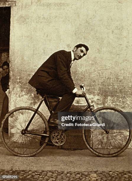 man on antique bicycle - antique stockfoto's en -beelden