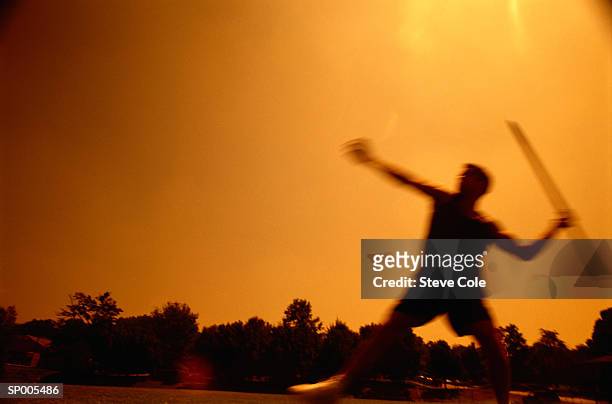 silhouette of a man throwing the javelin - mens field event stockfoto's en -beelden