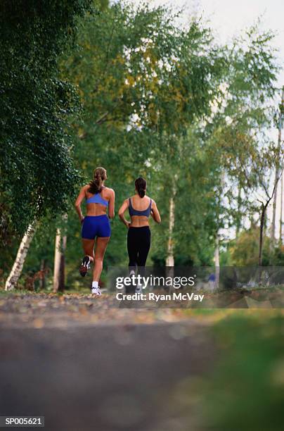 women running on a trail - ryan mcvay stock pictures, royalty-free photos & images
