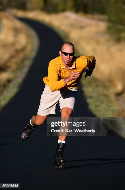 man inline skating on a trail - karl stock pictures, royalty-free photos & images