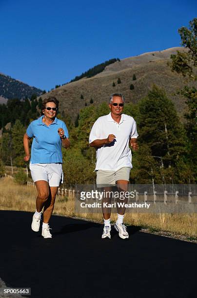 couple running on a trail - karl stock pictures, royalty-free photos & images