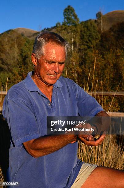 man checking his pulse - karl stock pictures, royalty-free photos & images