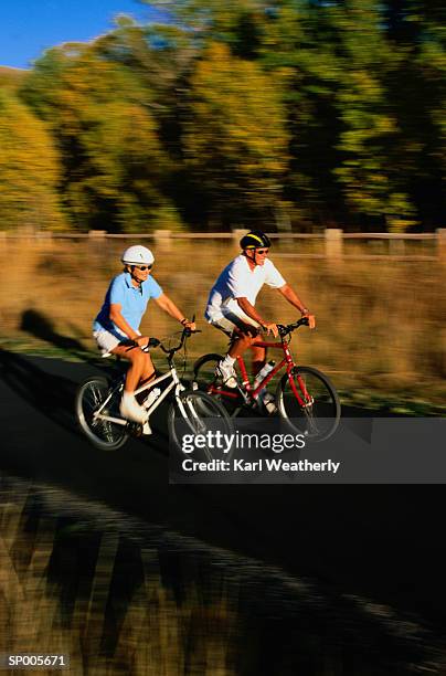 couple riding bicycles on a trail - karl stock pictures, royalty-free photos & images