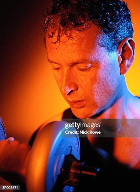 close-up of a man lifting a dumbbell - nick stock-fotos und bilder