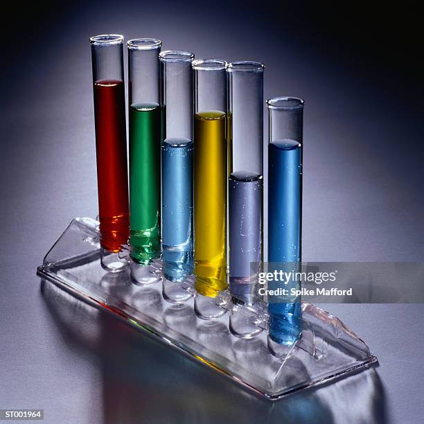 test tubes of colored liquid - test tube rack stock pictures, royalty-free photos & images