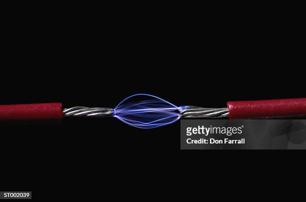 electric current transferred between wires - don farrall stock pictures, royalty-free photos & images