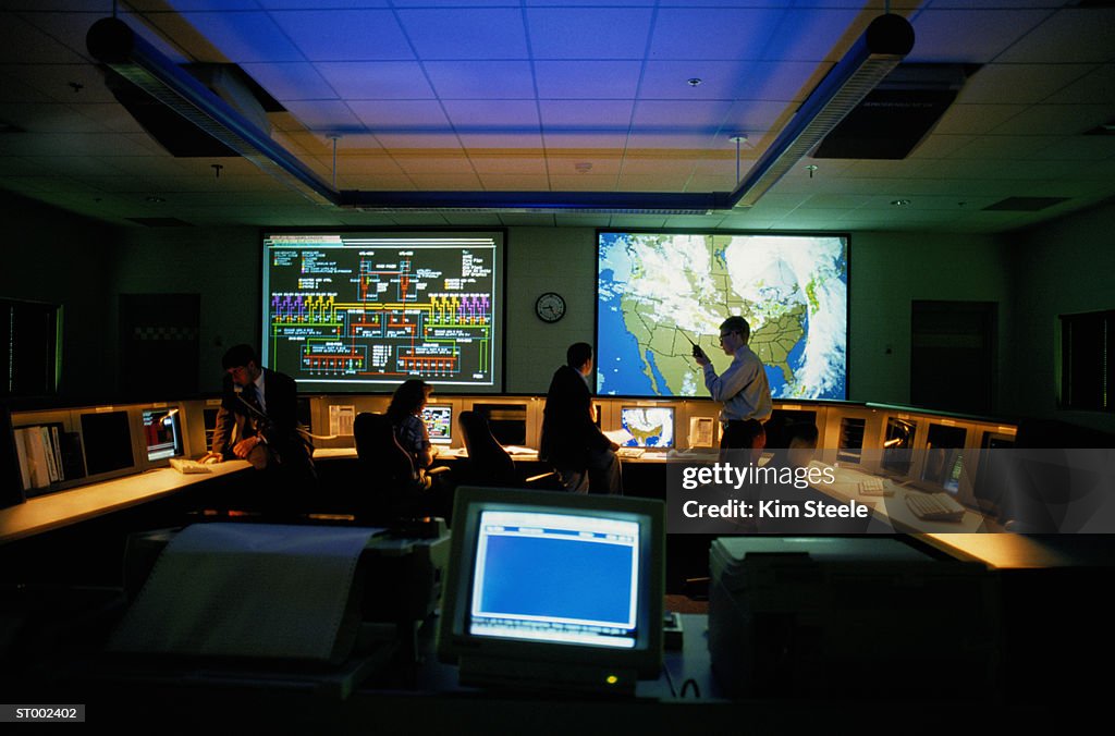 Meteorologists in a Weather Monitoring Room