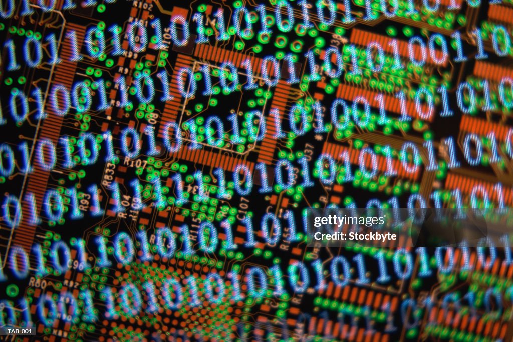 Binary code superimposed on printed circuit board