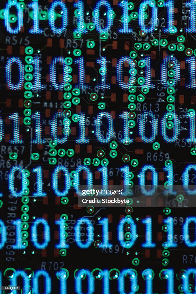 Binary code superimposed on circuit board