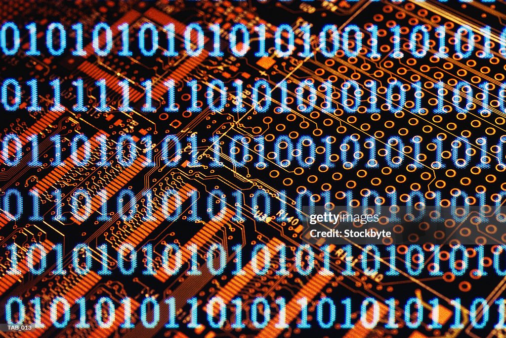 Binary code superimposed on circuit board