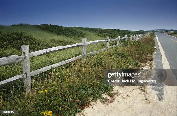 road and wooden fence - stakes in the sand stock pictures, royalty-free photos & images