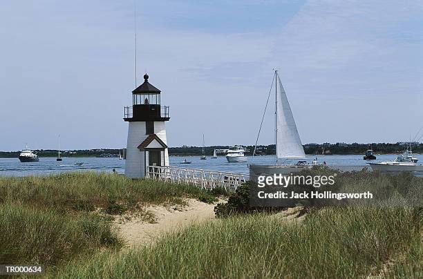 lighthouse and sailboat - jack and jack stock pictures, royalty-free photos & images