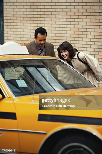 man and woman by taxi - by stock pictures, royalty-free photos & images