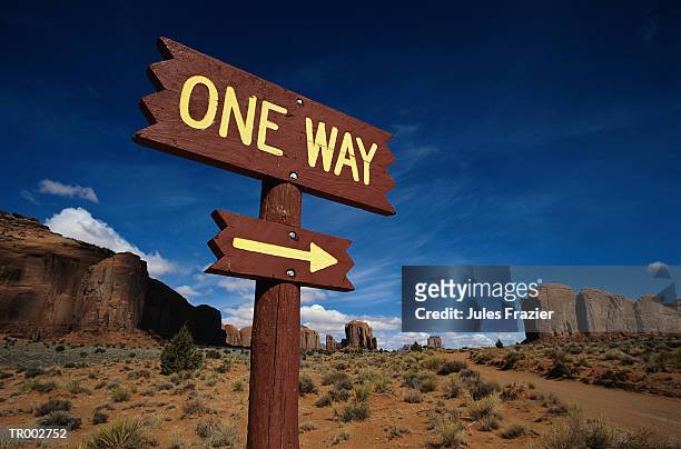 one way sign in desert - stakes in the sand stock pictures, royalty-free photos & images