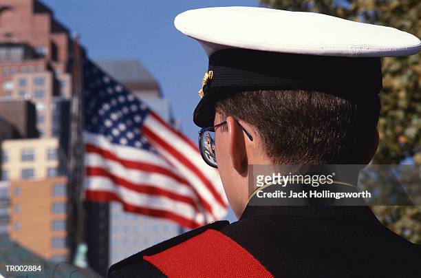 soldier looking at american flag - uniform cap imagens e fotografias de stock