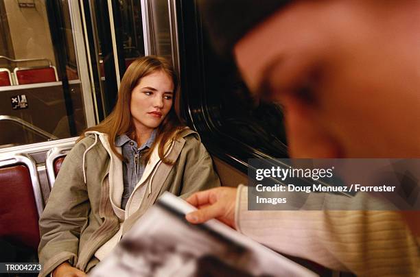 woman looking out window - get out stock-fotos und bilder