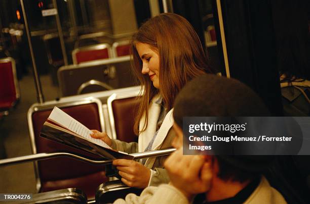 reading magazine on train - doug stock pictures, royalty-free photos & images