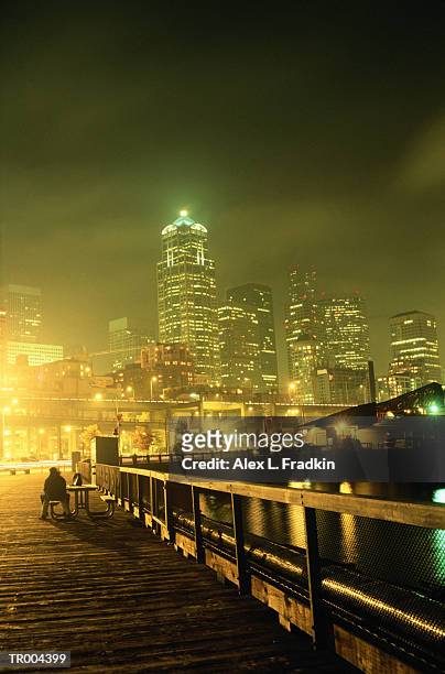 usa, washington, seattle, couple on dock, skyline in background, night - usa imagens e fotografias de stock