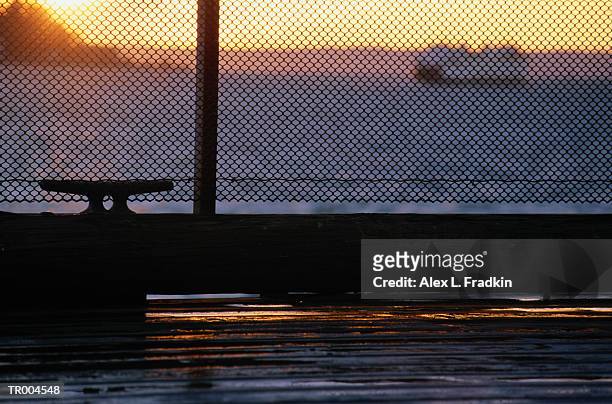 chain link fence on pier, ferry in background - north pacific ocean stock pictures, royalty-free photos & images