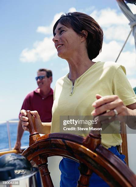 woman at the wheel of a sailboat - lesser antilles stock pictures, royalty-free photos & images