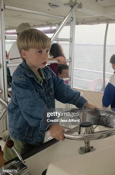 boy at ship's helm - peça de embarcação imagens e fotografias de stock