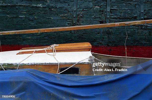 sailboat alongside old ship's hull - parte del barco fotografías e imágenes de stock