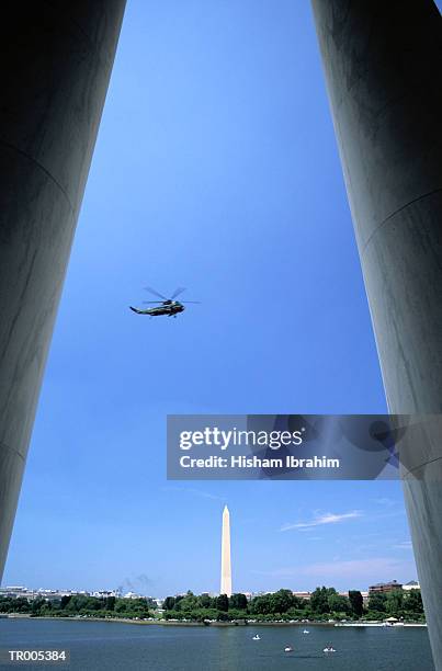 helicopter over washington monument - washington monument stock pictures, royalty-free photos & images