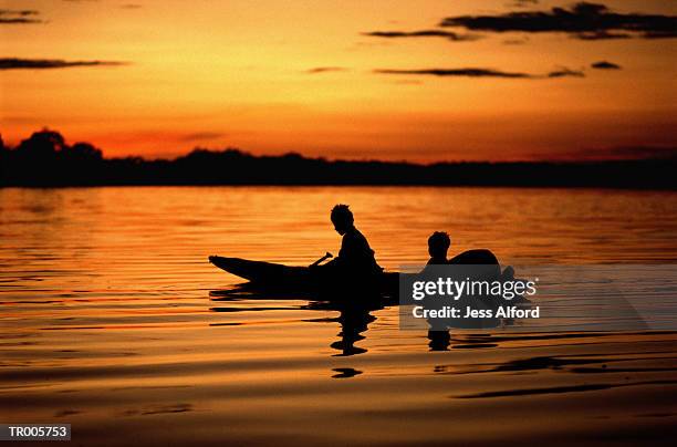 dugout canoe silhouette - northern brazil ストックフォトと画像