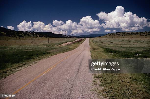 usa, new mexico, two lane road through prairie - usa imagens e fotografias de stock