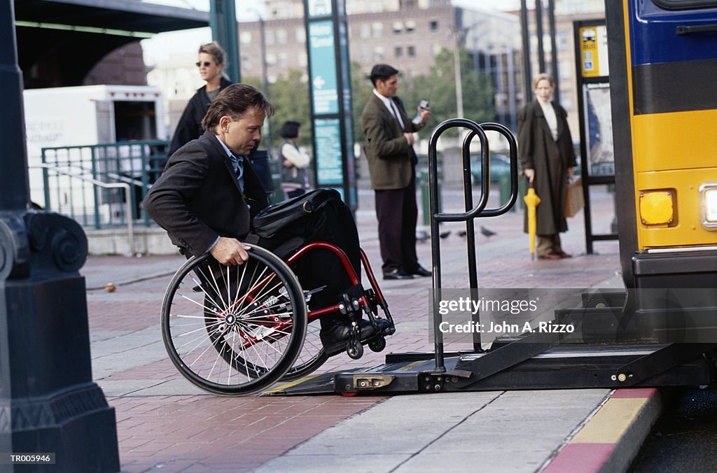 Man in Wheelchair Entering Bus