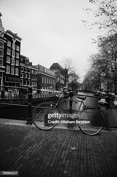 bicycle by railing - human powered vehicle stock pictures, royalty-free photos & images