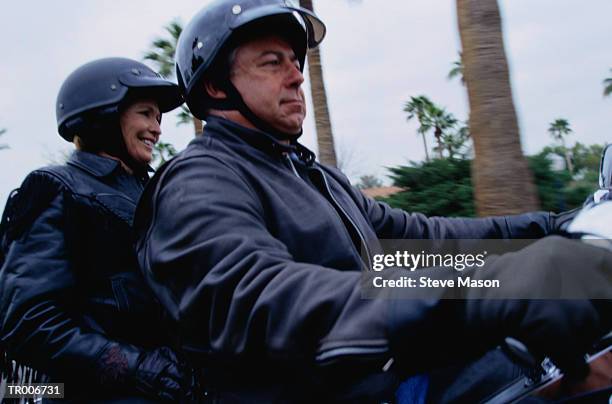 couple in leather jackets riding motorcycle - women black and white motorcycle fotografías e imágenes de stock