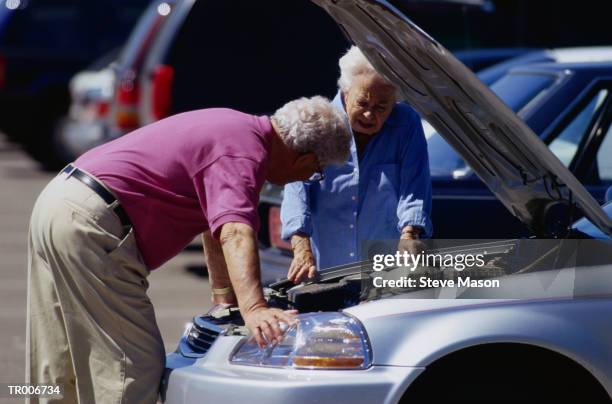 man looking under car hood - steve stock pictures, royalty-free photos & images